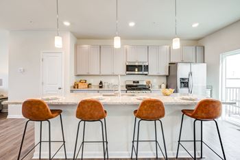 Kitchen with Island Counter and Stools at Refinery Row, Baltimore, MD